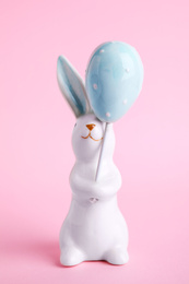 Photo of Bunny ceramic figure as Easter decor on pink background