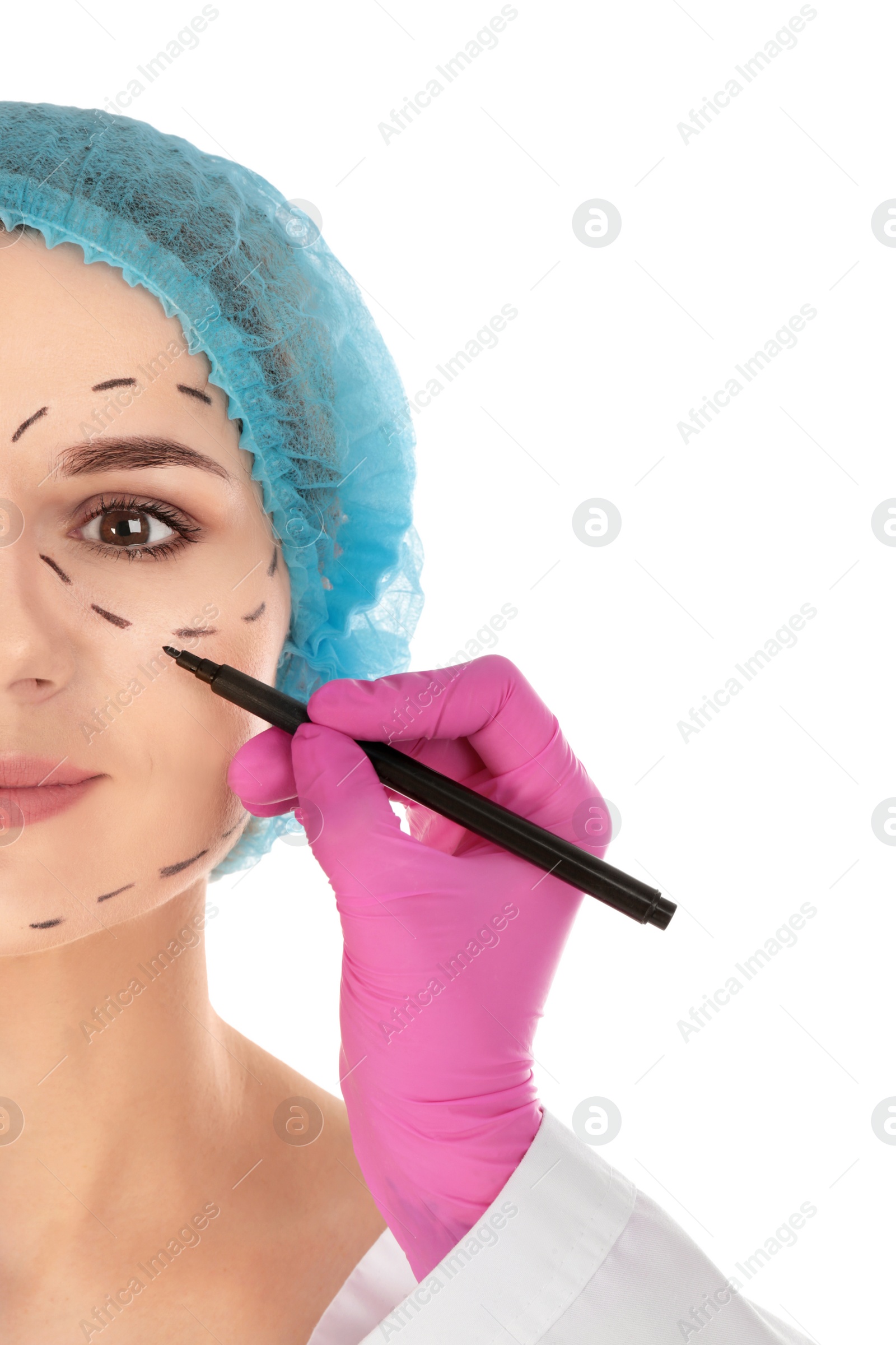 Photo of Doctor drawing marks on woman's face against white background. Cosmetic surgery