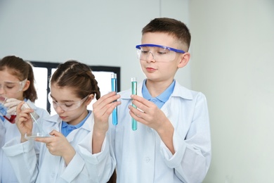 Smart pupils making experiment in chemistry class