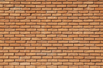Photo of Texture of orange brick wall as background
