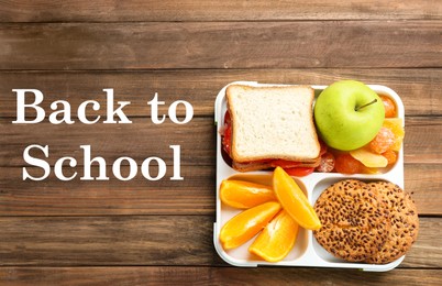 Image of Lunch box with appetizing food on wooden table, top view