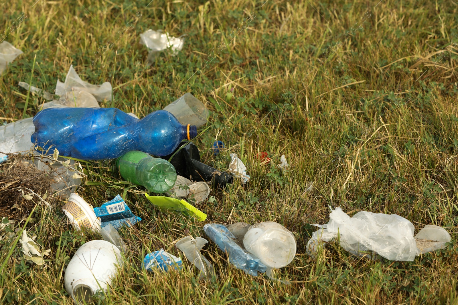 Photo of Garbage scattered on grass. Environment pollution problem