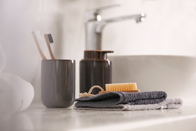 Photo of Toiletries on light countertop in light bathroom, closeup