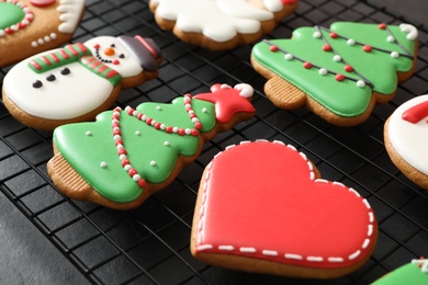Photo of Delicious Christmas cookies on cooling rack, closeup