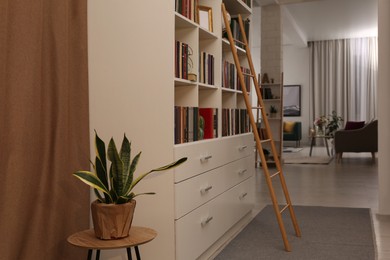 Photo of Home library interior with collection of different books on shelves