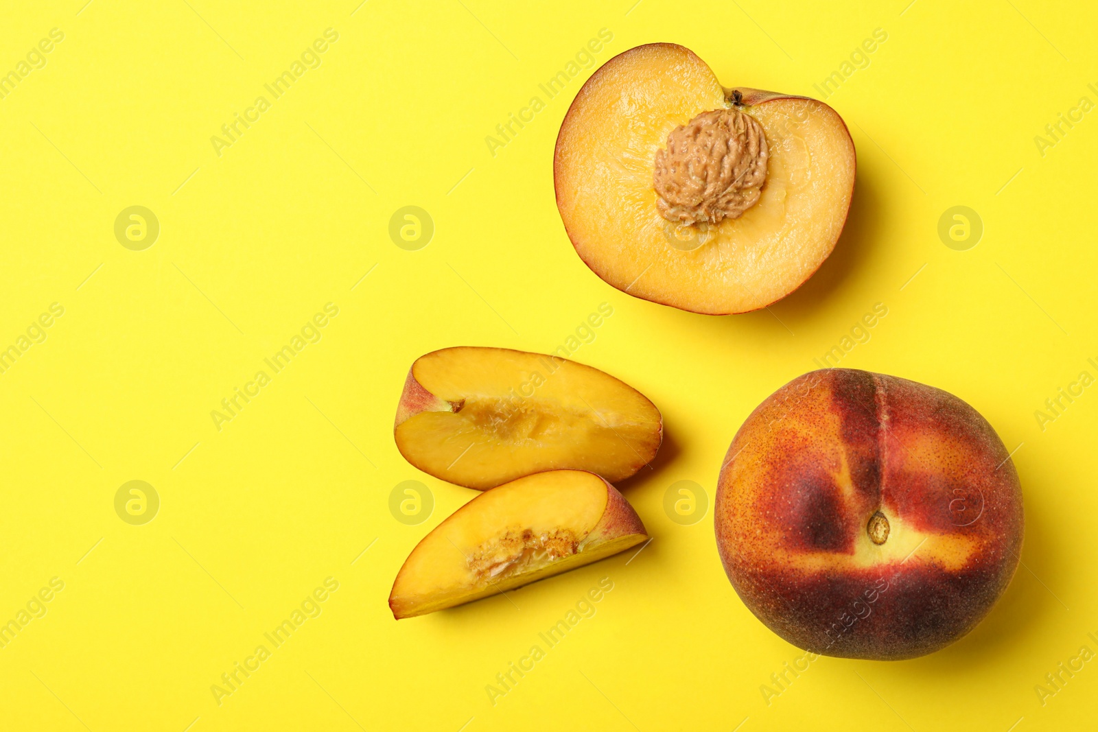 Photo of Flat lay composition with ripe peaches on yellow background