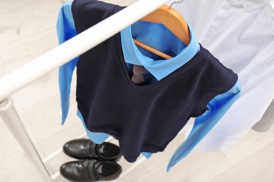 Photo of School uniform for boy on hanger indoors