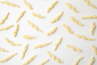 Photo of Uncooked trofie pasta on white background, flat lay
