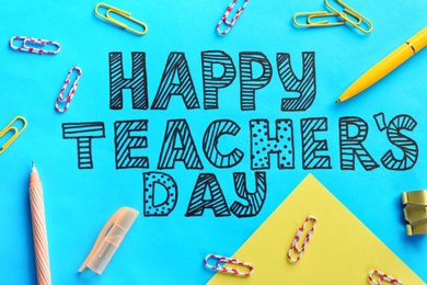 Photo of Text HAPPY TEACHER'S DAY and stationery on color paper