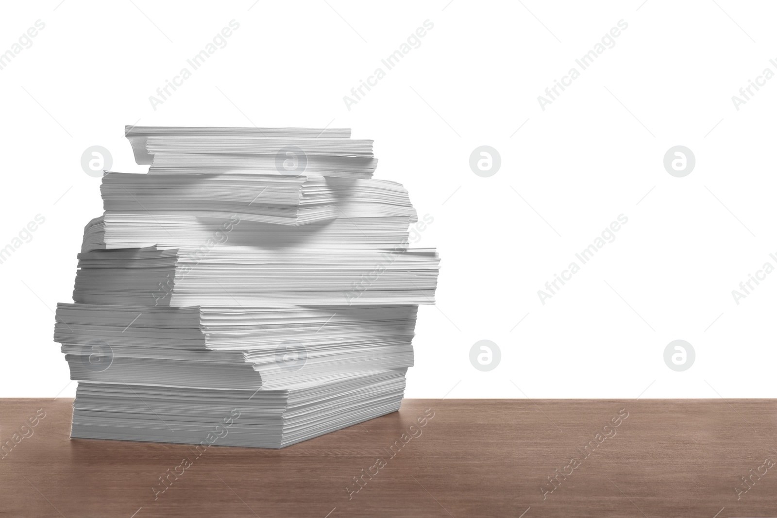 Photo of Stack of paper sheets on wooden table against white background. Space for text