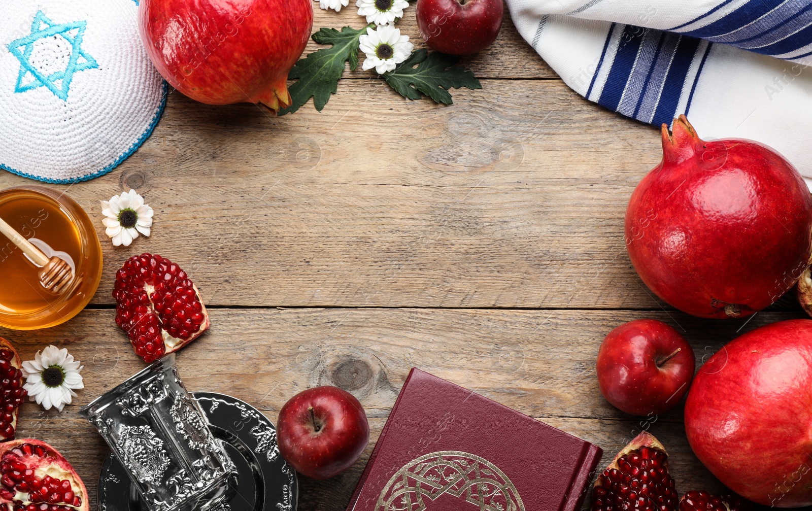 Photo of Frame of Rosh Hashanah holiday attributes on wooden table, flat lay. Space for text