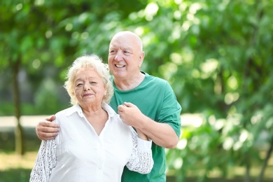 Photo of Portrait of cute elderly couple in park