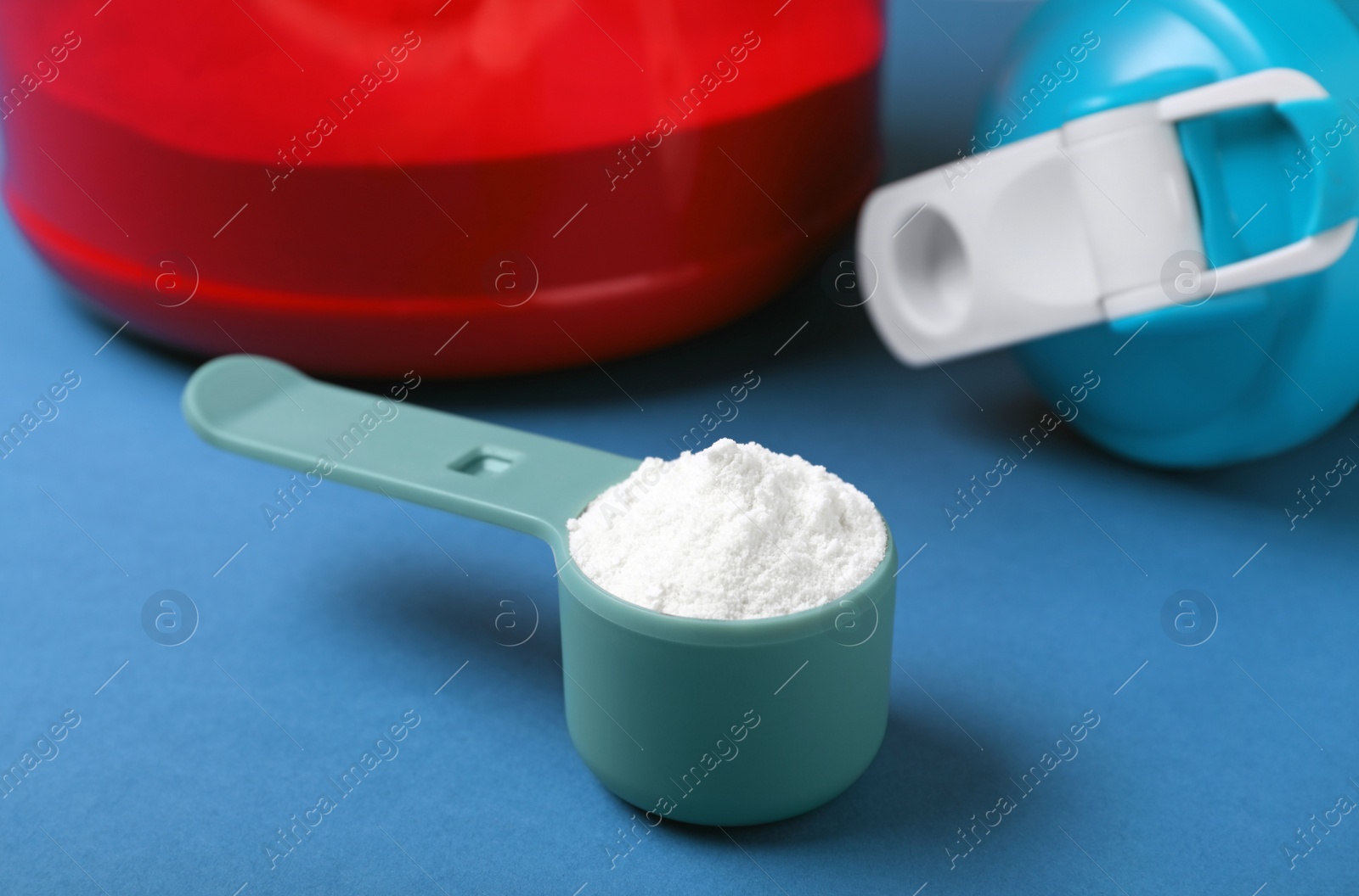 Photo of Measuring scoop with protein powder on table