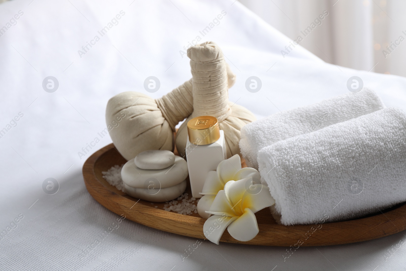 Photo of Beautiful composition with spa stones on white fabric, closeup