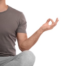 Photo of Man meditating on white background, closeup. Harmony and zen