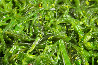 Japanese seaweed salad as background, closeup view