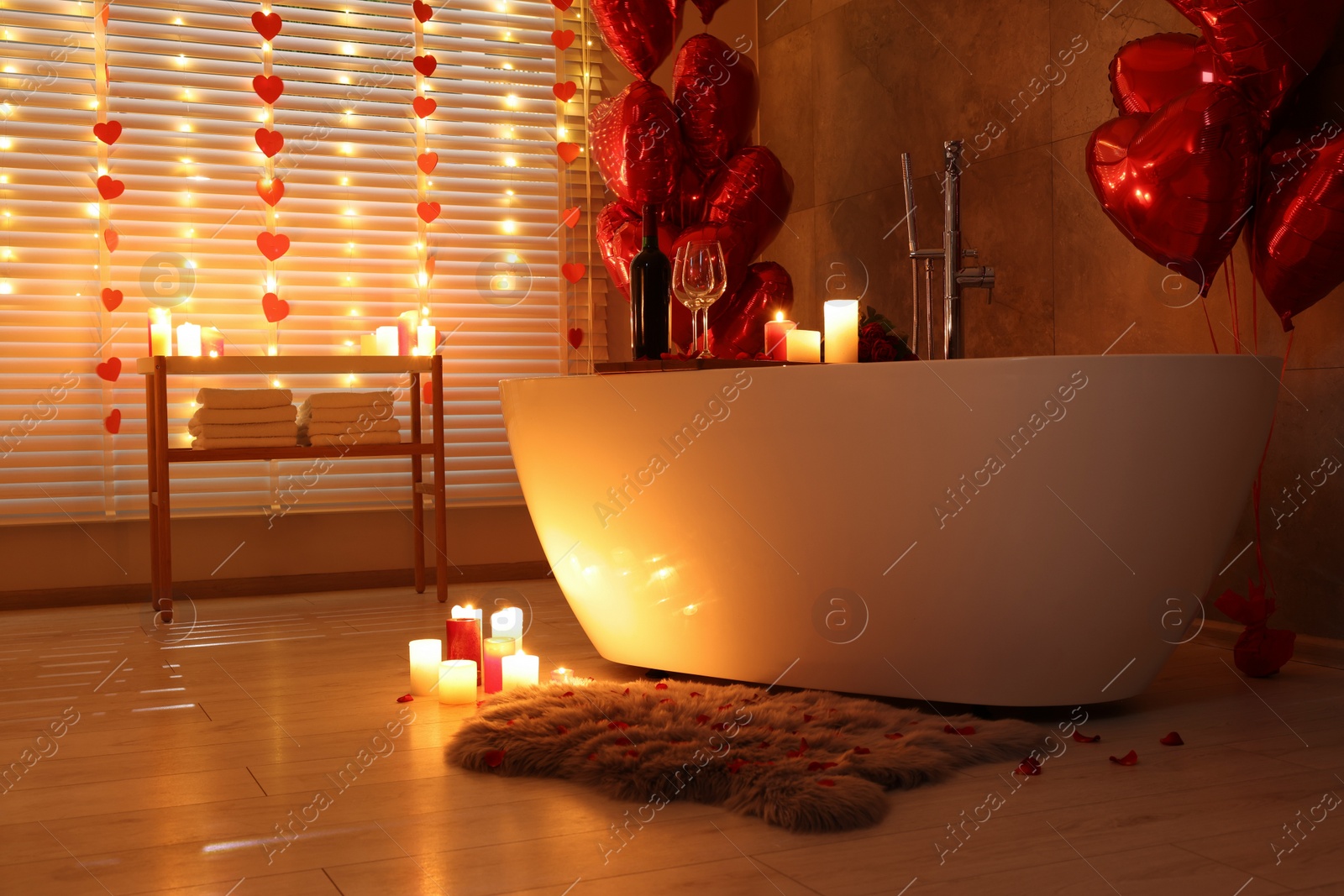 Photo of Stylish bathroom decorated for Valentine's day. Interior design