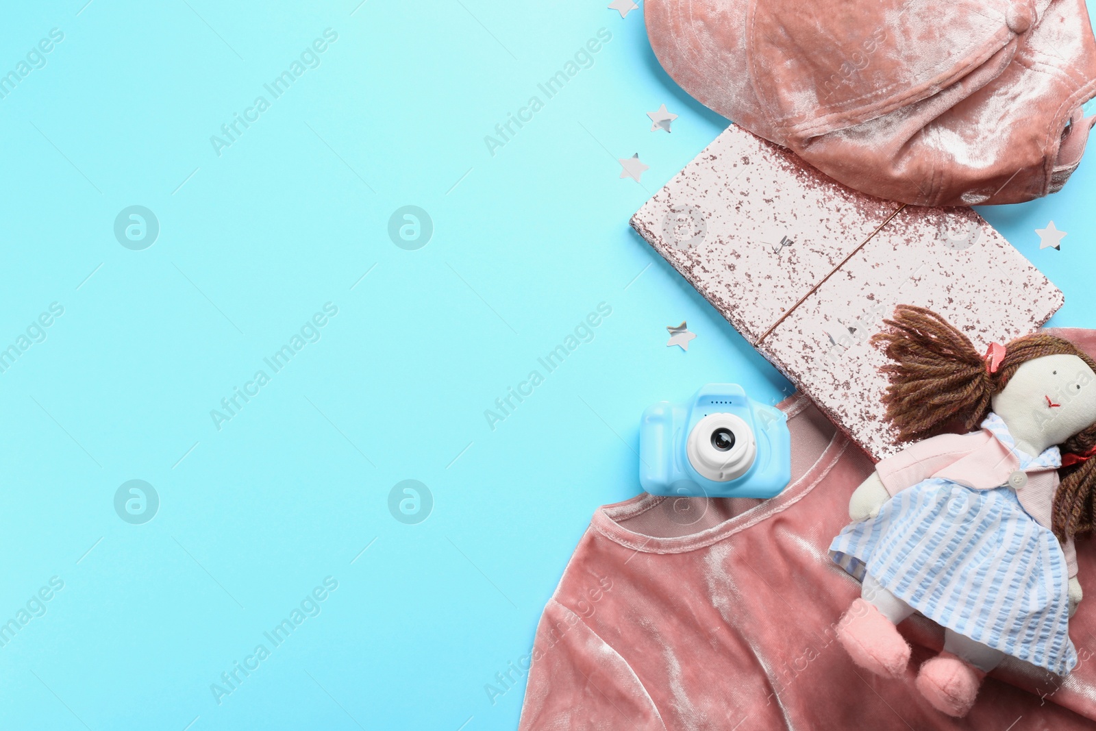 Photo of Flat lay composition with little photographer's toy camera on light blue background. Space for text