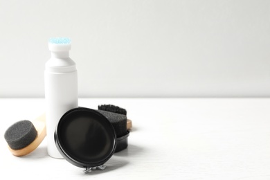 Photo of Composition with shoe care accessories on white table, space for text