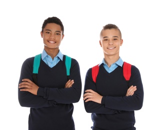 Photo of Portrait of teenage boys in school uniform with backpacks on white background