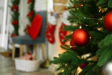 Blurred view of beautiful festive interior, focus on decorated Christmas tree