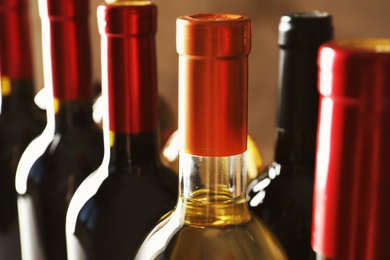 Photo of Bottles with delicious wine, closeup. Professional sommelier