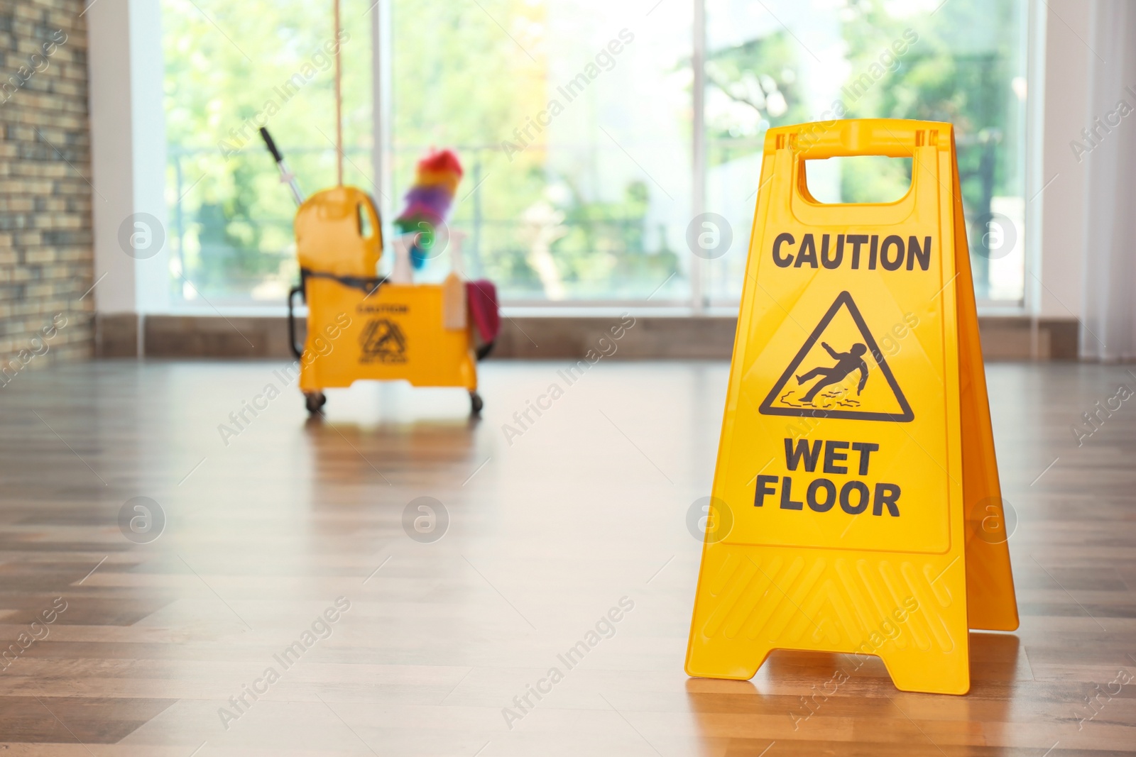 Photo of Safety sign with phrase Caution wet floor, indoors