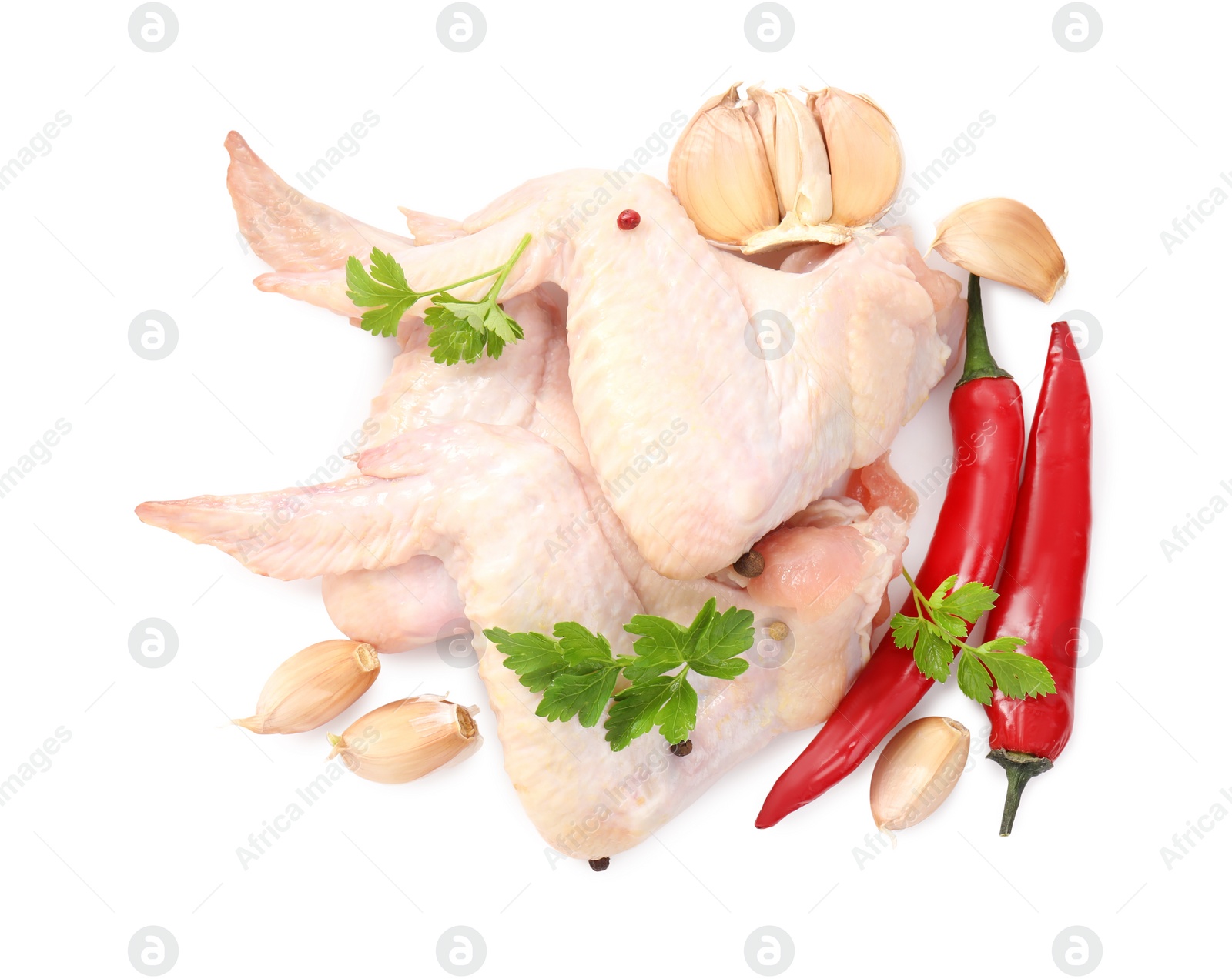 Photo of Raw chicken wings with spices and parsley on white background, top view