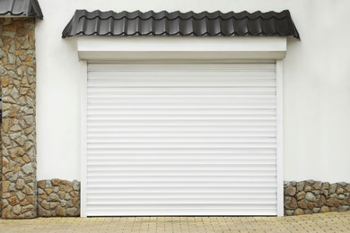 Building with white roller shutter garage door