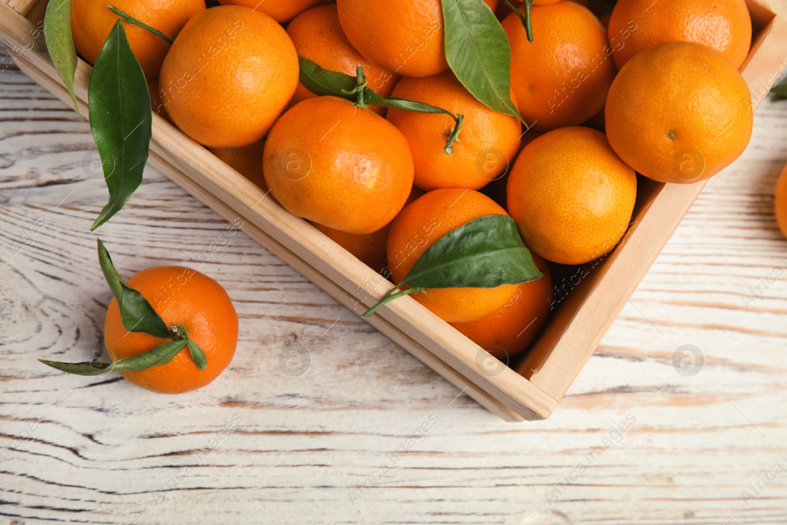 Photo of Crate with fresh ripe tangerines on wooden background, top view