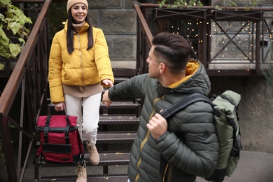 Photo of Couple with travel backpacks outdoors. Urban trip