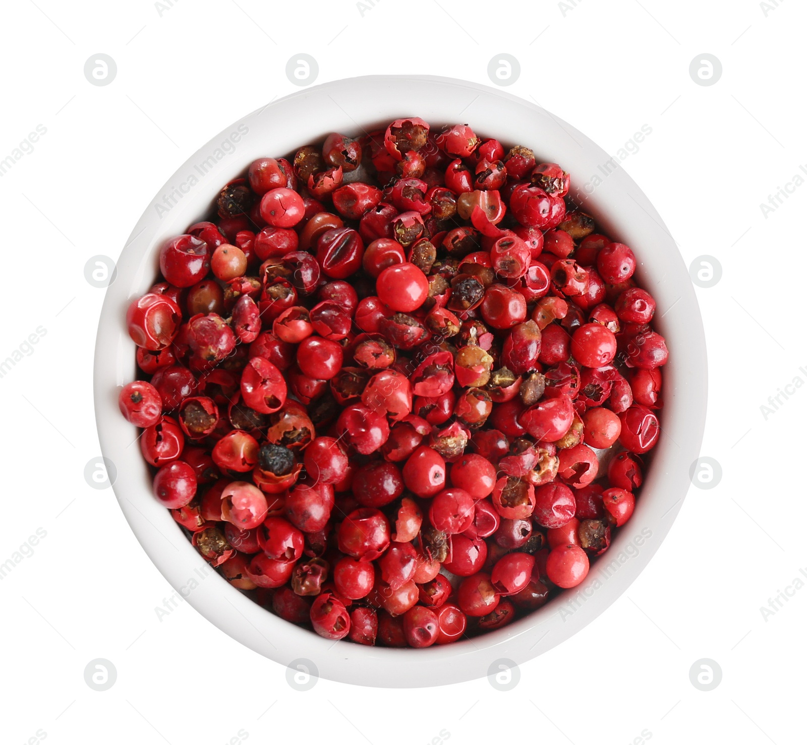 Photo of Bowl of red peppercorns isolated on white, top view