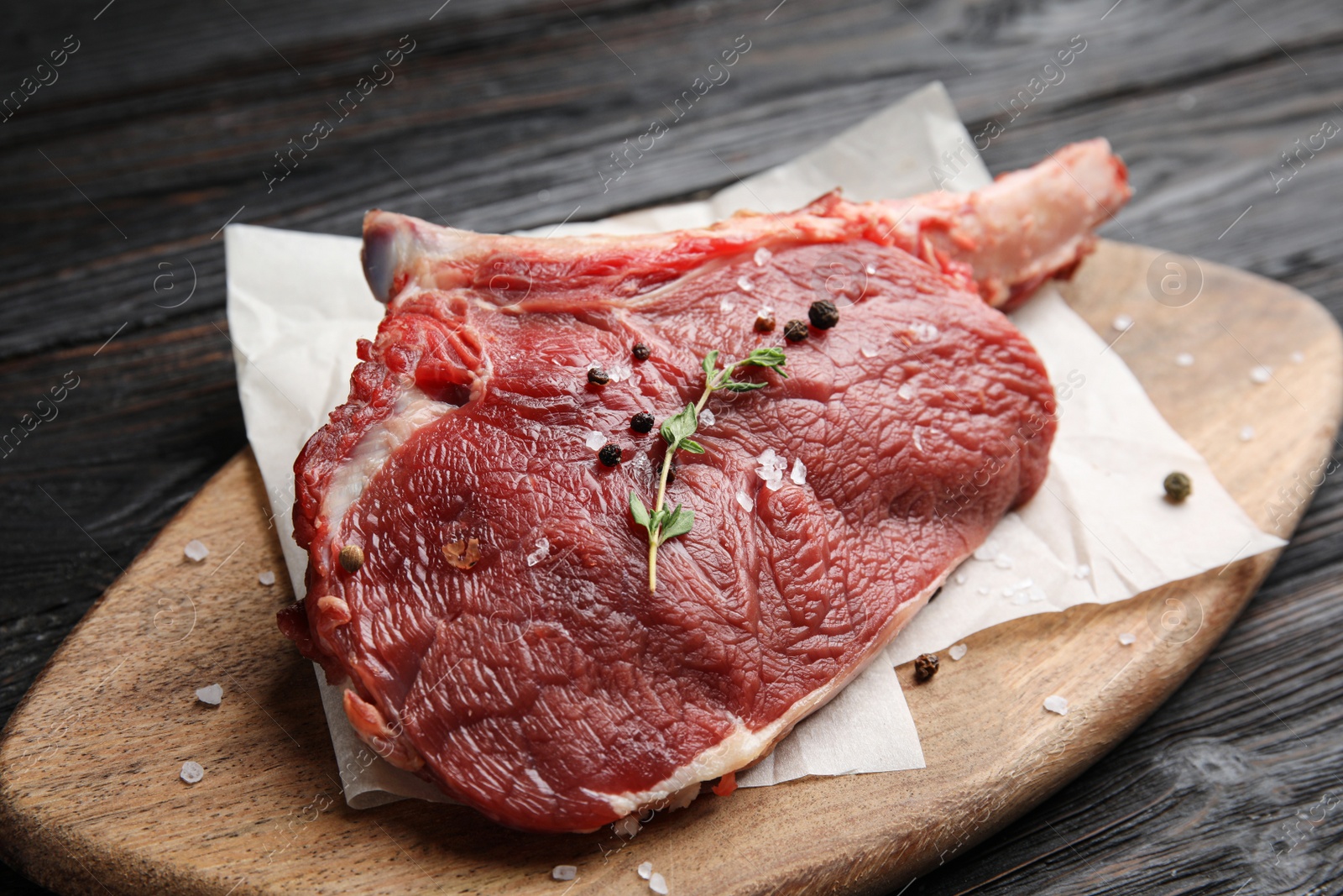 Photo of Fresh raw beef cut on wooden table, closeup