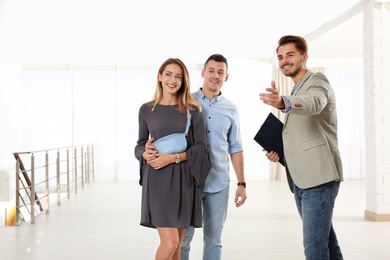 Real estate agent showing new apartment to young couple