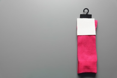 Pair of colorful socks on gray background with space for text