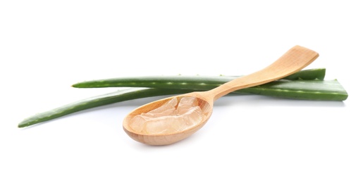 Photo of Wooden spoon with aloe vera gel and green leaves on white background