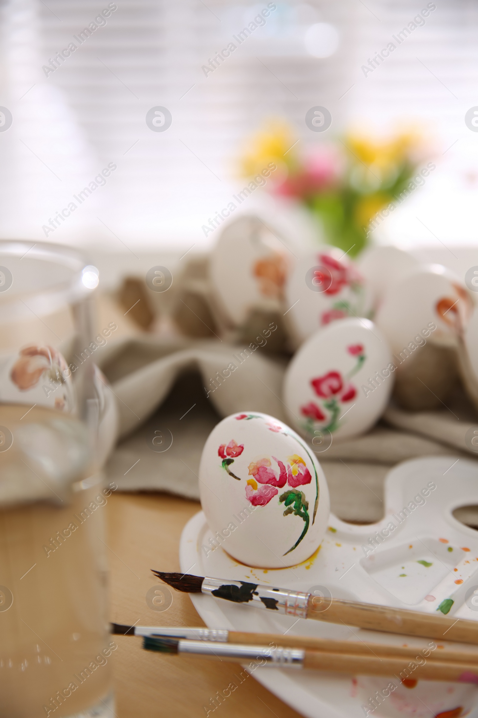 Photo of Beautifully painted Easter eggs on table indoors