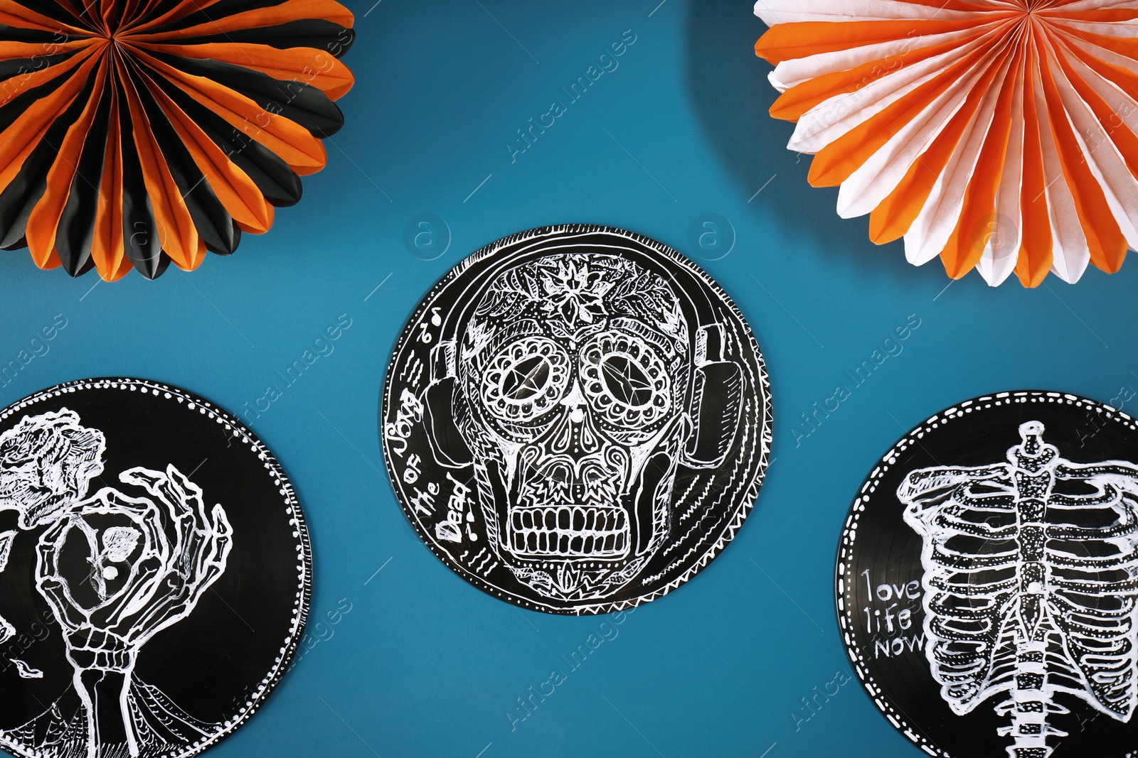 Photo of Halloween decorations on blue background, flat lay