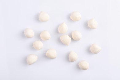 Tasty mozzarella balls on white background, flat lay