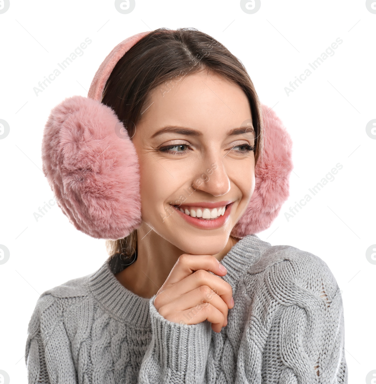 Photo of Happy woman wearing warm earmuffs on white background