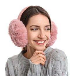 Happy woman wearing warm earmuffs on white background