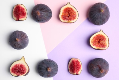 Delicious ripe figs on color background, flat lay. Space for text