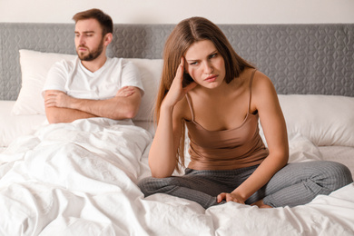 Unhappy couple with relationship problems after quarrel in bedroom