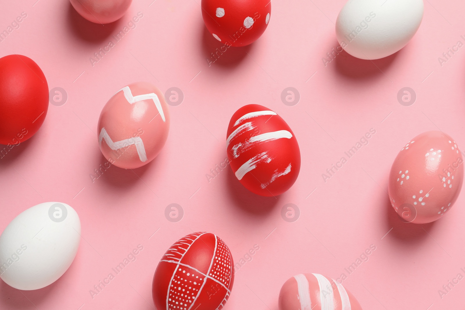 Photo of Flat lay composition of painted Easter eggs on color background