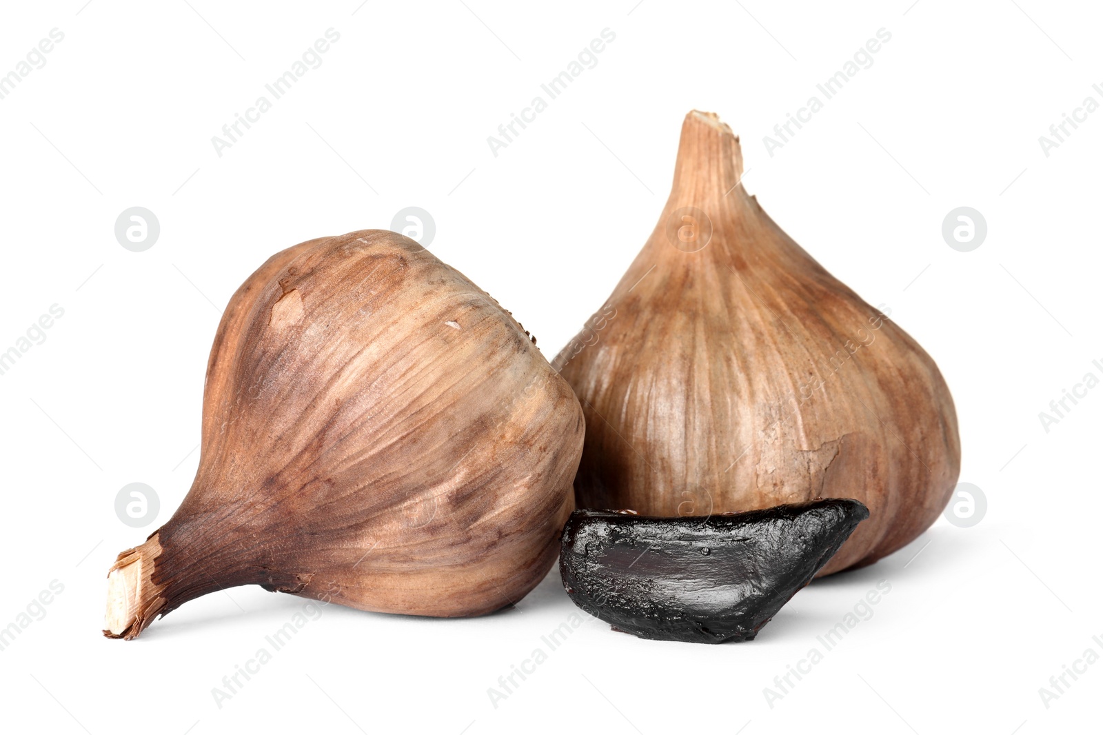 Photo of Aged black garlic on white background. Asian cuisine