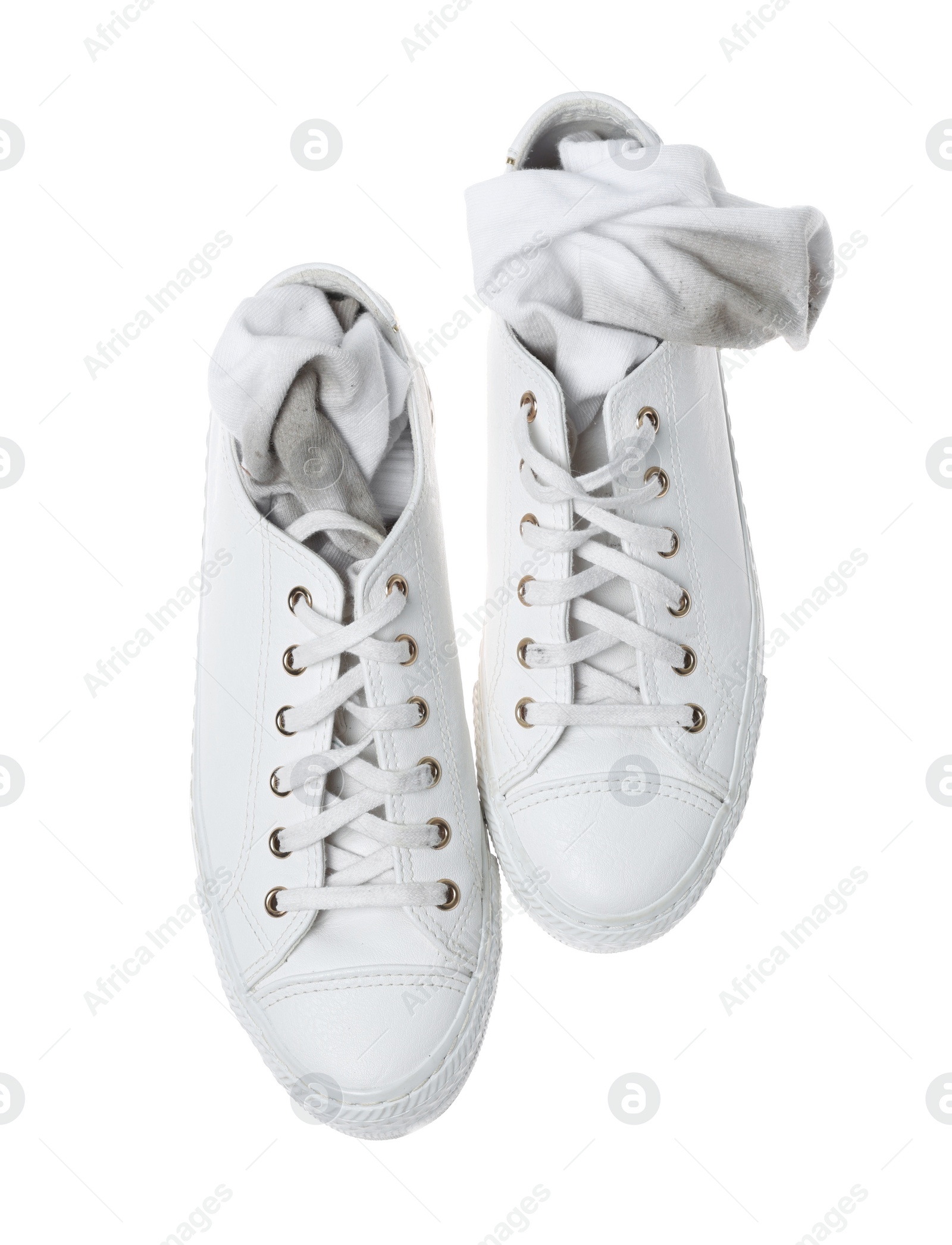 Photo of Dirty socks and sneakers on white background, top view