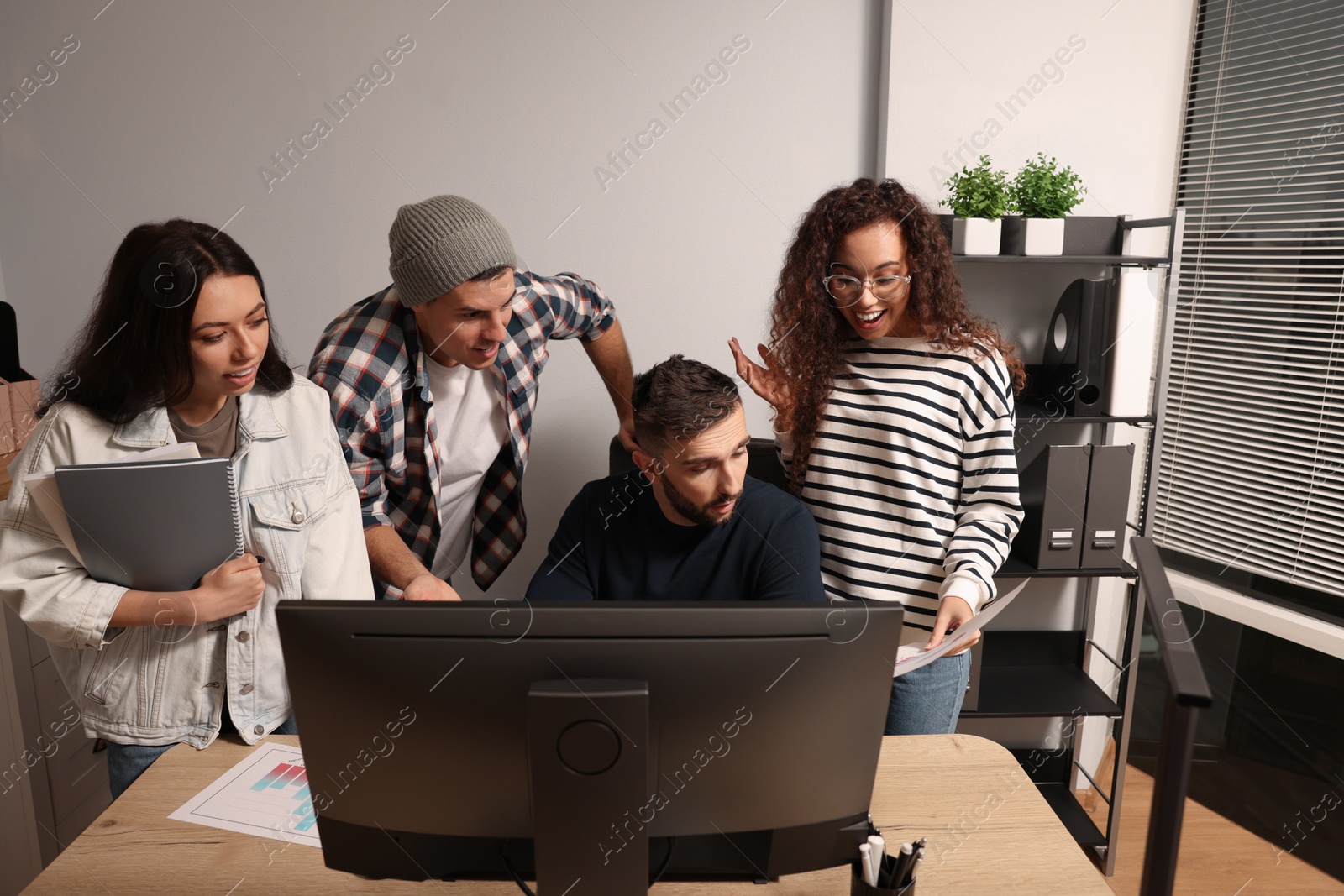 Photo of Team of employees working together in office. Startup project