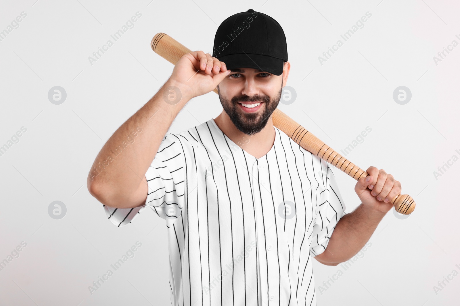 Photo of Man in stylish black baseball cap holding bat on white background