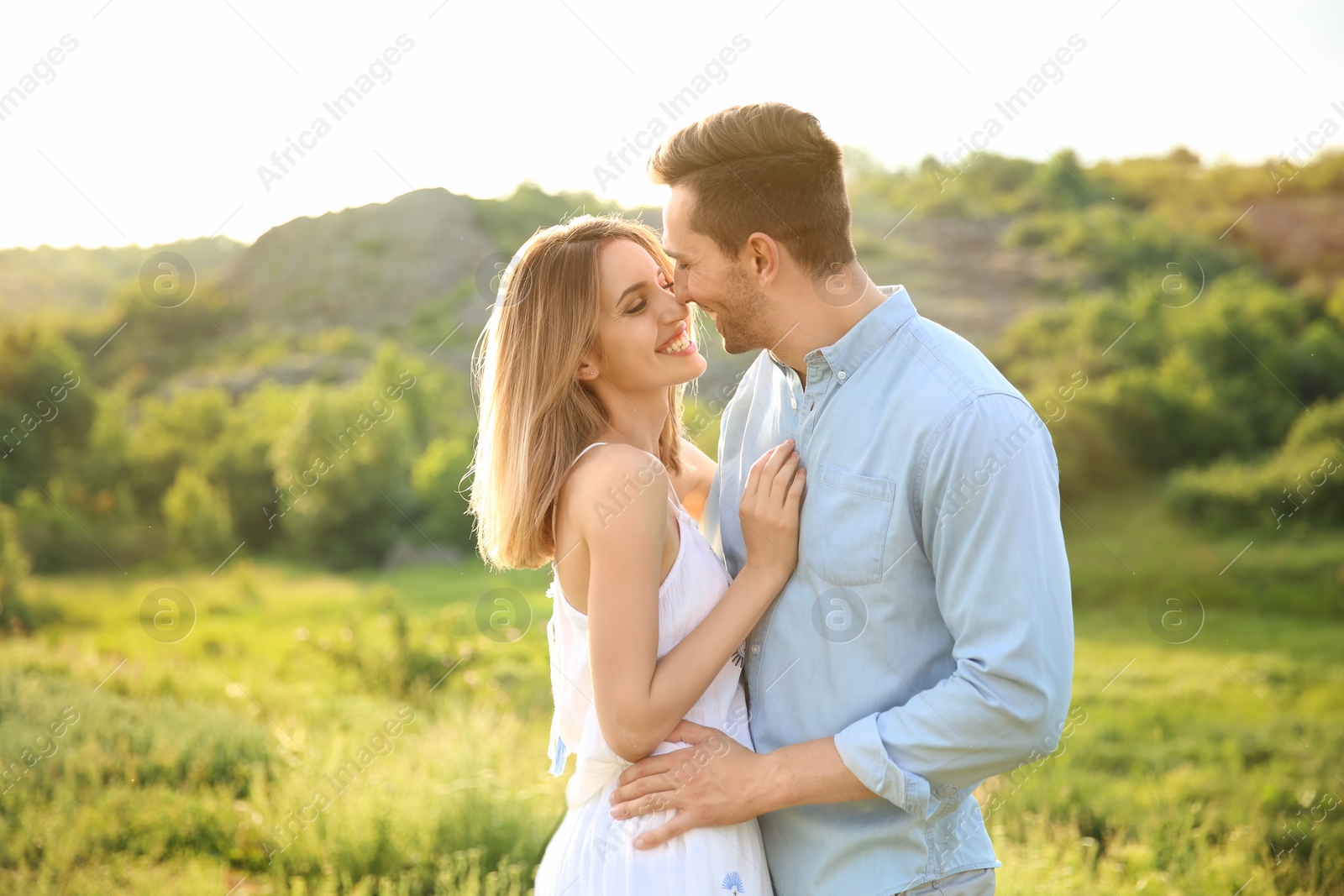 Photo of Cute young couple in love posing outdoors on sunny day