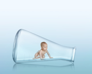 Image of Little baby in conical flask on light background
